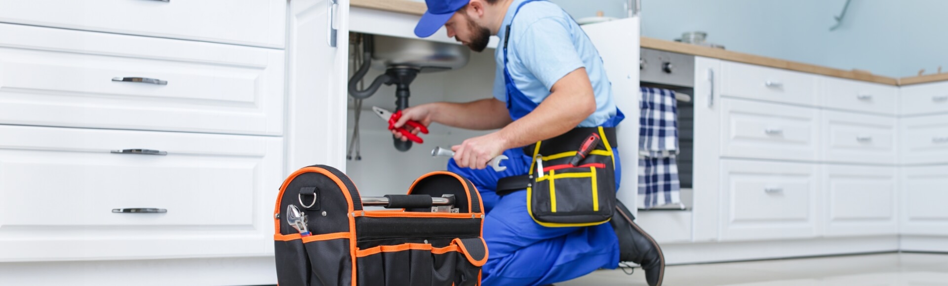 Professional plumber preparing tools and equipment for a plumbing repair