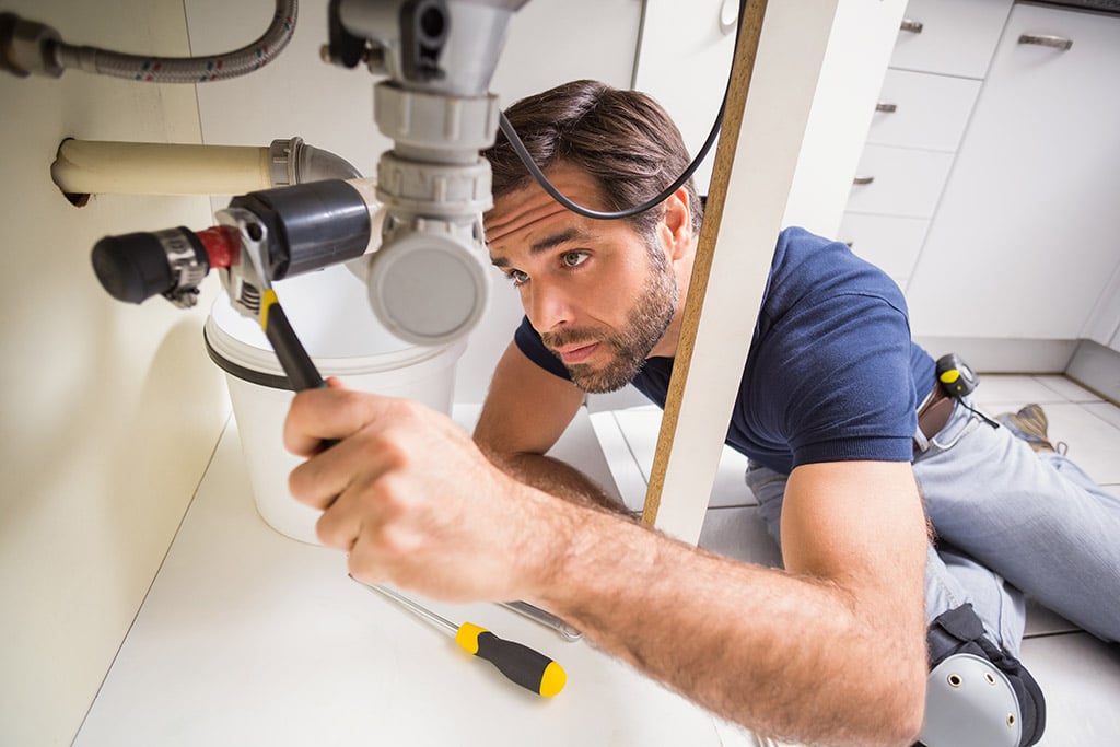 Professional plumber preparing tools and equipment for a service visit