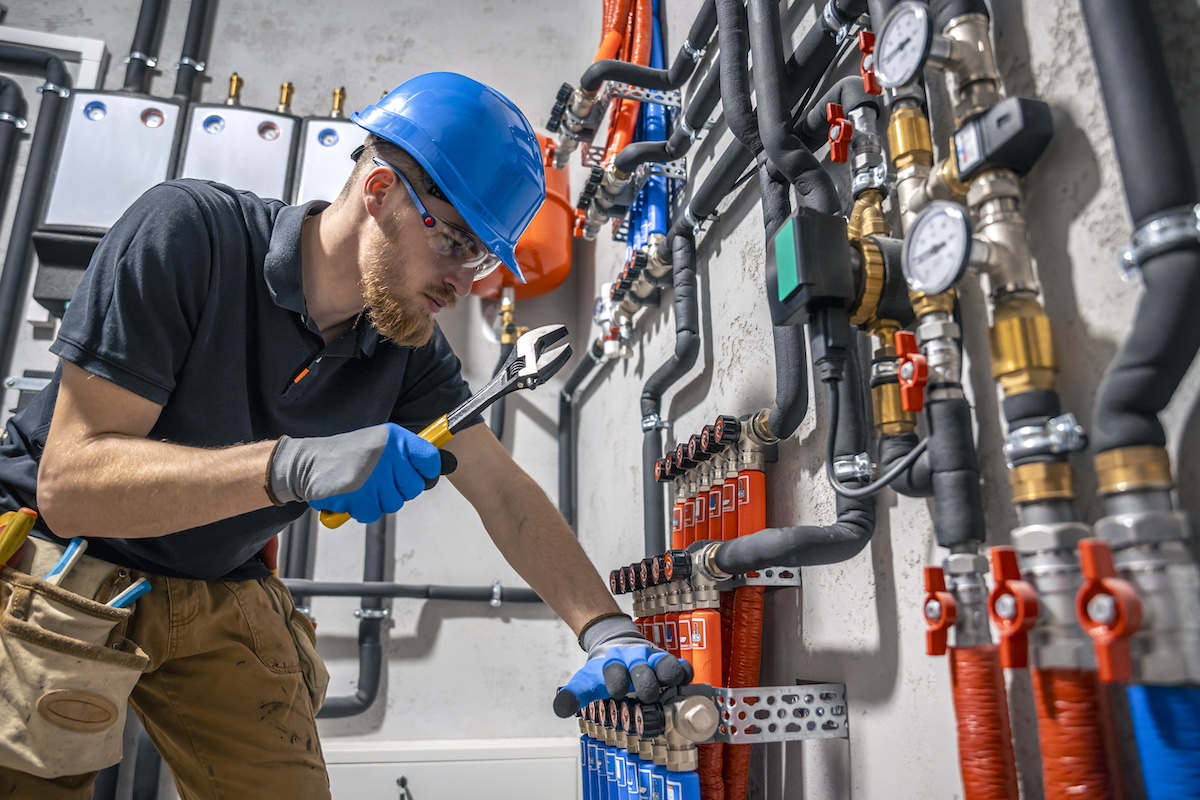 Professional plumber checking pipes and household plumbing connections